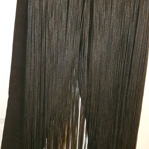 Black jeans with tassels on the front